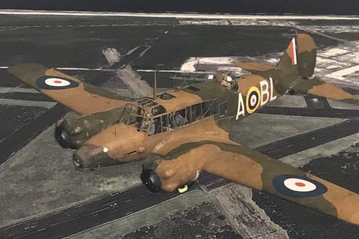 An Historical Image of an Avro Anson aircraft flying over fields